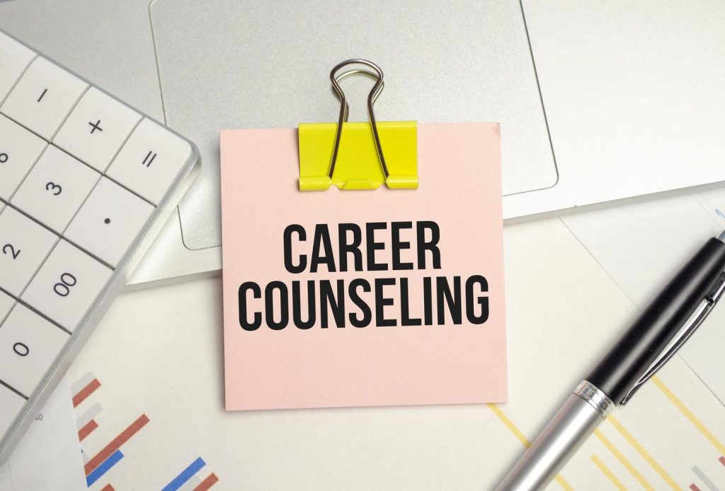 career counseling word on sticker on notepad with pen and calculator free photo